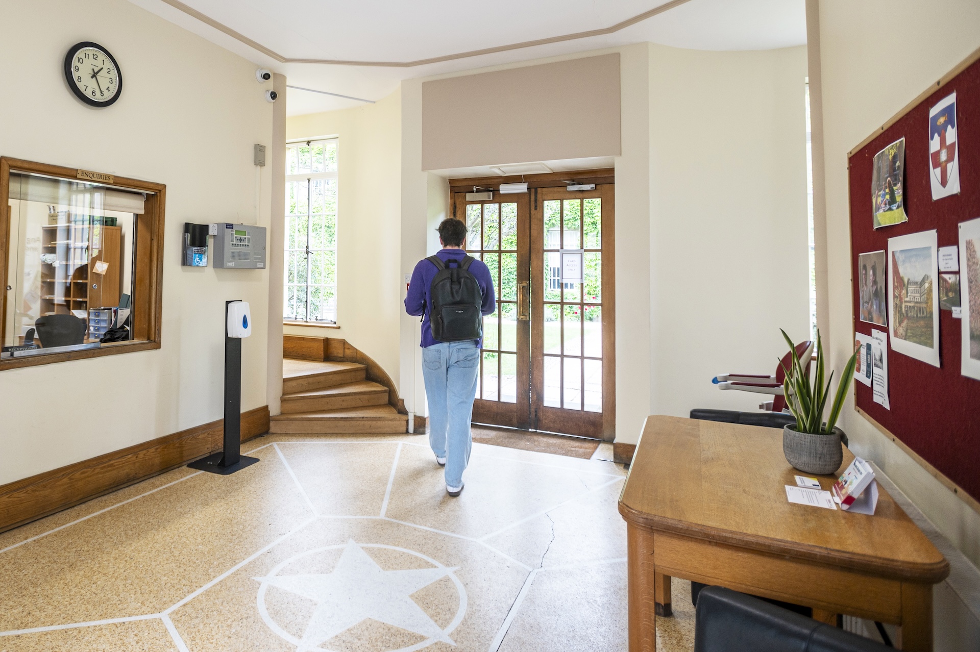Student about to walk through the door of an Oxford college building